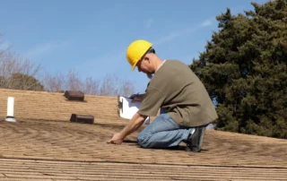 The Importance of Roof Inspection: home inspector checking a homeowner’s roof